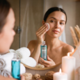 women cleaning face with snail tonic